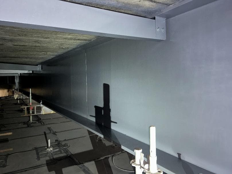 Primed grey steelwork inside the enclosure after decontamination